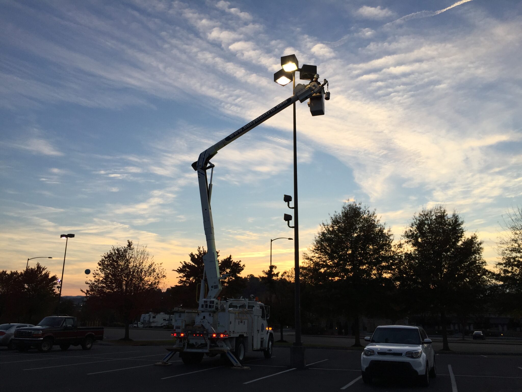 Intech bucket truck servicing parking lot lighting