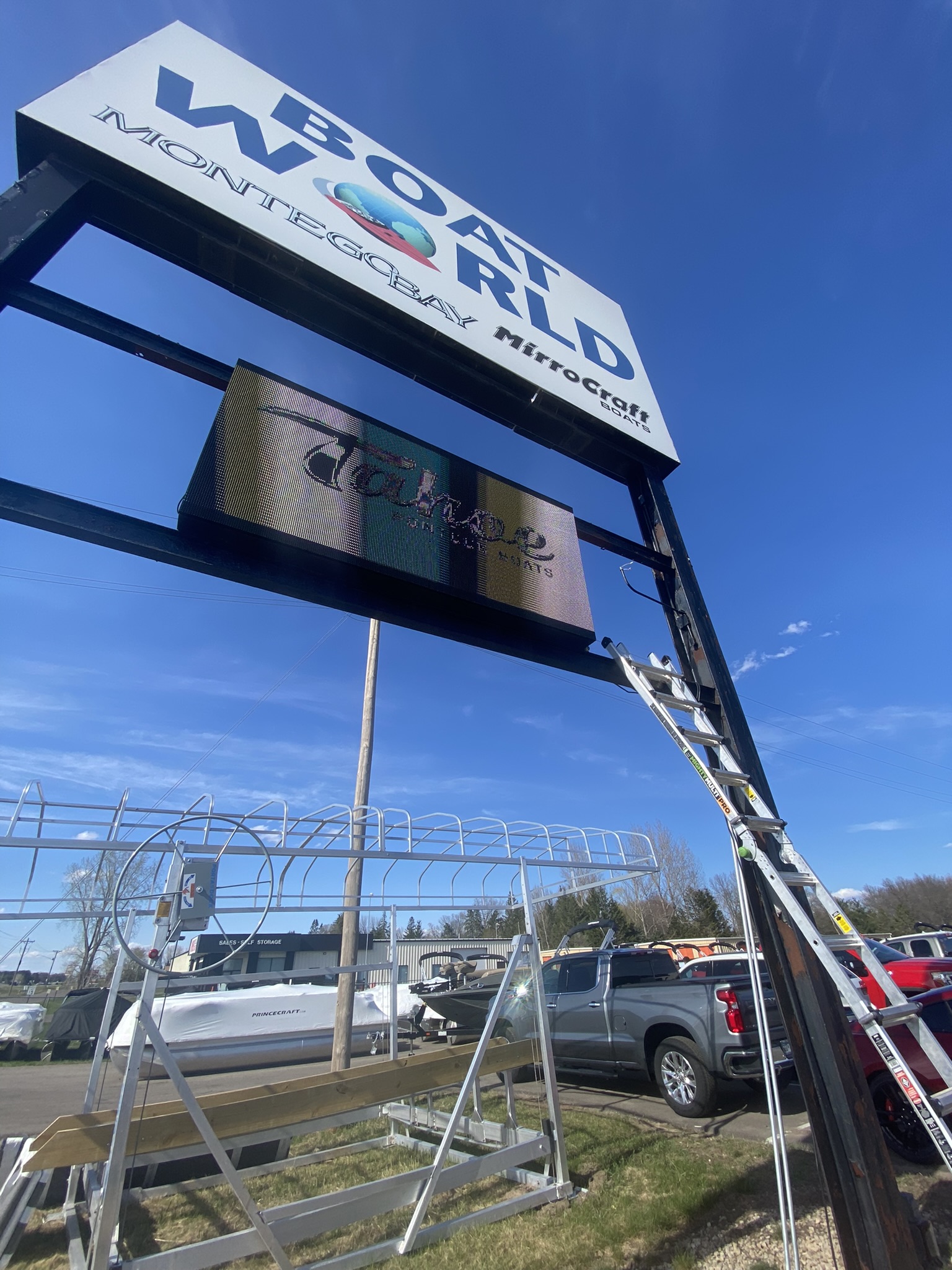 Intech technician servicing a pylon sign's digital display