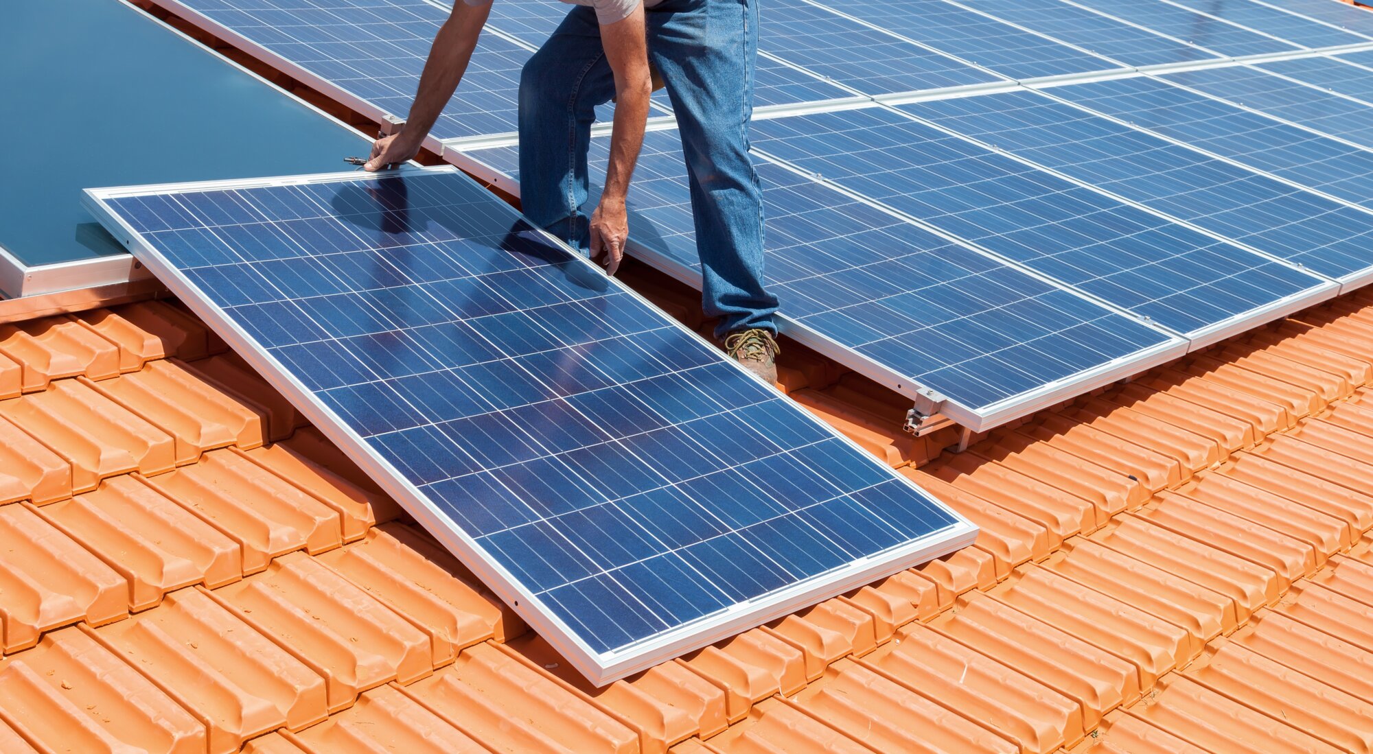Solar panels being installed on a residential roof